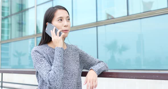 Woman talk to cellphone in street