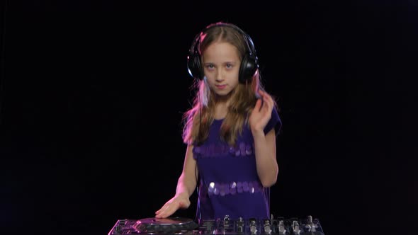 Teen Girl Dj in Headphones Plays for Console. Black Background alt