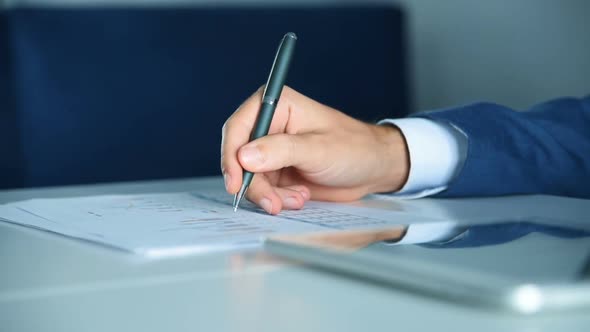 Trader Analyzing Business Report On Paper And Tablet.