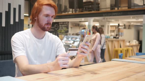 Redhead Man in Cafe Shopping Online on Smartphone Payment