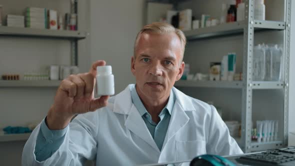 Doctor Holds the Pills Bottle in Hand and Tells You About It's Properties