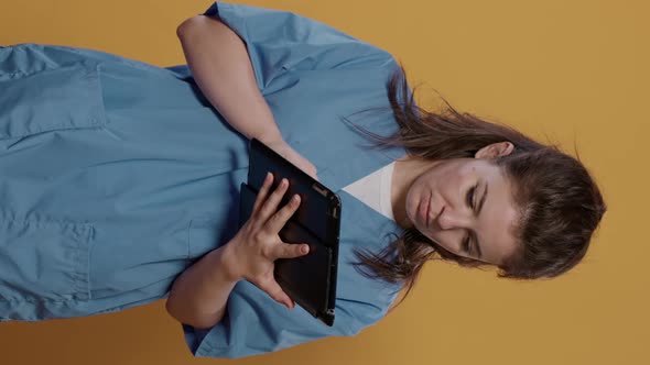 Portrait of Doctor Holding Tablet Computer and Typing Medical Data Showing Green Screen Mockup