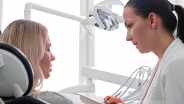 Dentist and patient discussing some medical record