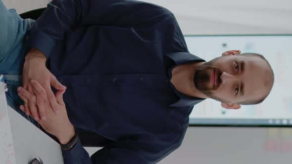 Vertical Video Portrait of Businessman Sitting at Desk with Computer