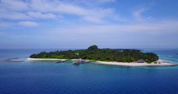 Tropical fly over travel shot of a sandy white paradise beach and blue water background in best quality