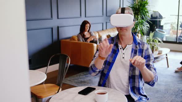Businessman using virtual reality headset in the lobby at office 4k