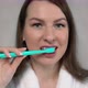 Woman in White Bathrobe Cleans Her Teeth with Toothbrush and Paste After Shower - VideoHive Item for Sale