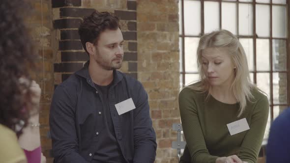 Couple making up and talking during group therapy session