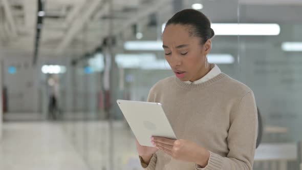 Upset African Woman Having Loss on Tablet