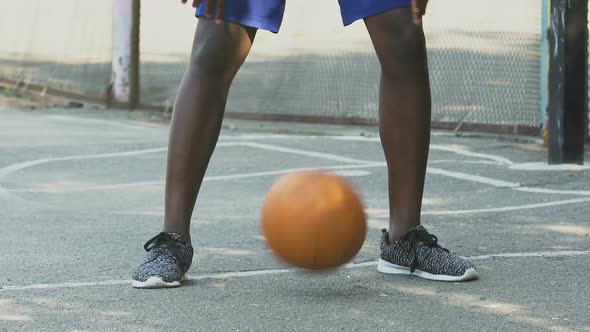 Sportive Black Man Making Tricks with Ball, Playing Basketball, Active Lifestyle