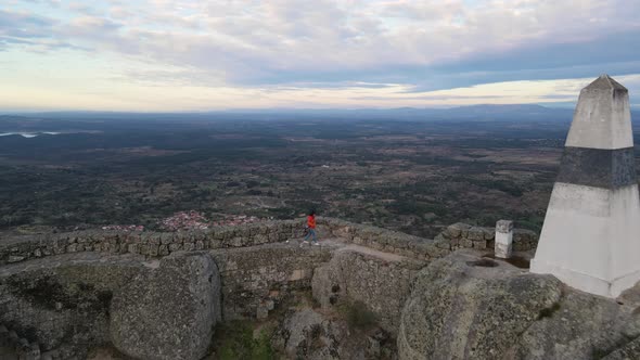 Drone camera moving from the Monsanto Castle towards the surrounding area to capture the picturesque