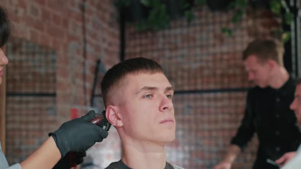 Male Haircut with Electric Razor. Close Up of Man Hair Cut. Male Hands Barber Shaving Man with