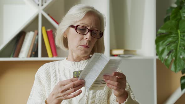 Old Woman Reading Medicine Pills Instruction. Senior Lady Reading Instruction Pills