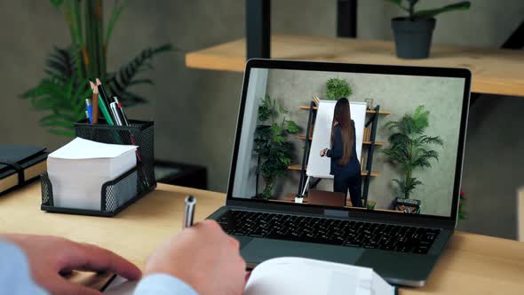 Businessman Writes in Notebook Study Watch Business Online Course Laptop Webcam