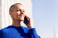 confident woman talking on mobile phone at city - PhotoDune Item for Sale