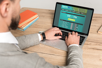 of businessman using laptop with Sportsbet website