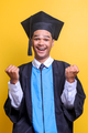 Young man wearing graduation gown screaming proud, celebrating victory and success  - PhotoDune Item for Sale