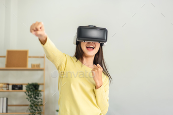 to playing boxing games with virtual experience while using hands to clench fist and punches to exercise and training in living room at home.