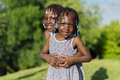 Two little african american girls hugging in the park - PhotoDune Item for Sale