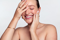 Happy woman with clean skin touching face - PhotoDune Item for Sale