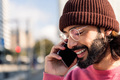 stylish man smiling happy talking on smart phone - PhotoDune Item for Sale