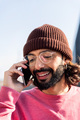 stylish man smiling happy talking on smart phone - PhotoDune Item for Sale