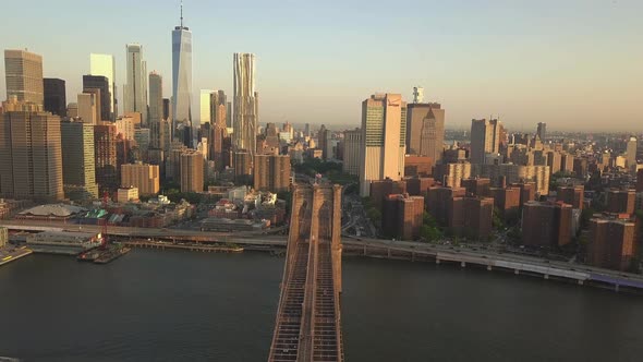 AERIAL: Flight Over Brooklyn Bridge with View Over Manhattan New York City Skyline at Sunset in