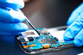 Asian Technician repairing micro circuit main board of smartphone electronic technology. - PhotoDune Item for Sale