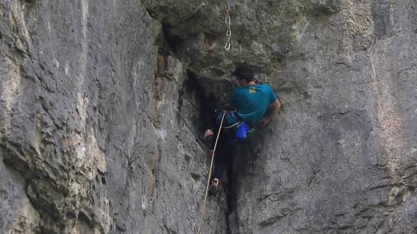 A man rock climbing up a mountain.