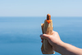 Hot dog in hand against the sky. Fast food. Snack on the street. - PhotoDune Item for Sale