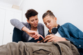 Teen boy addicted to technology watching social video at home with his mother - PhotoDune Item for Sale