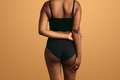 Crop plump black woman in underwear with hands behind back - PhotoDune Item for Sale