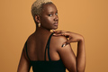 Black woman touching shoulder in studio - PhotoDune Item for Sale