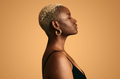 Dreamy black woman with closed eyes against beige background - PhotoDune Item for Sale