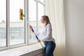 Washing window with special mop and cleaning services - housework and housewife concept - PhotoDune Item for Sale