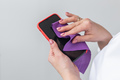 Closeup woman hands cleaning the smartphone screen with a fiber cloth from dirt dust and virus - PhotoDune Item for Sale