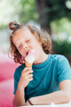 Cute curly boy eating cone ice cream. Child licking ice cream - PhotoDune Item for Sale