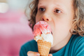 Closeup portrait of boy eating cone ice cream. Child licking ice cream. - PhotoDune Item for Sale