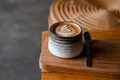 Grey ceramic cup of cappuccino with latte art on wooden background. - PhotoDune Item for Sale