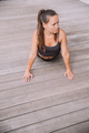 A sporty woman in sportswear on wooden floor doing yoga - PhotoDune Item for Sale