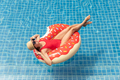 Beautiful woman with inflatable donut in pool - PhotoDune Item for Sale