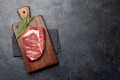 Raw ribeye steak on cutting board - PhotoDune Item for Sale