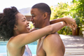 Loving Smiling Couple On Holiday Hugging In Swimming Pool - PhotoDune Item for Sale