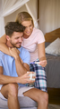Excited Couple In Bedroom At Home Celebrating Positive Pregnancy Test Result - PhotoDune Item for Sale