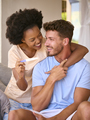 Excited Multi-Racial Couple In Bedroom At Home Celebrating Positive Pregnancy Test Result - PhotoDune Item for Sale