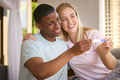 Excited Multi-Racial Couple In Bedroom At Home Celebrating Positive Pregnancy Test Result - PhotoDune Item for Sale