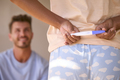 Woman In Bedroom Hiding Positive Pregnancy Test Behind Back To Surprise Partner - PhotoDune Item for Sale