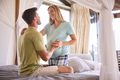 Couple With Pregnant Woman In Bedroom At Home With Man Feeling Baby Kicking - PhotoDune Item for Sale