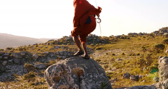 Tribal man standing on a rock 