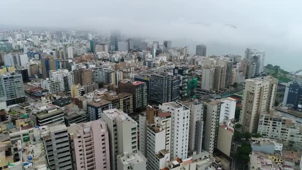 drone view over Lima Peru, high buildings and ocean on the background